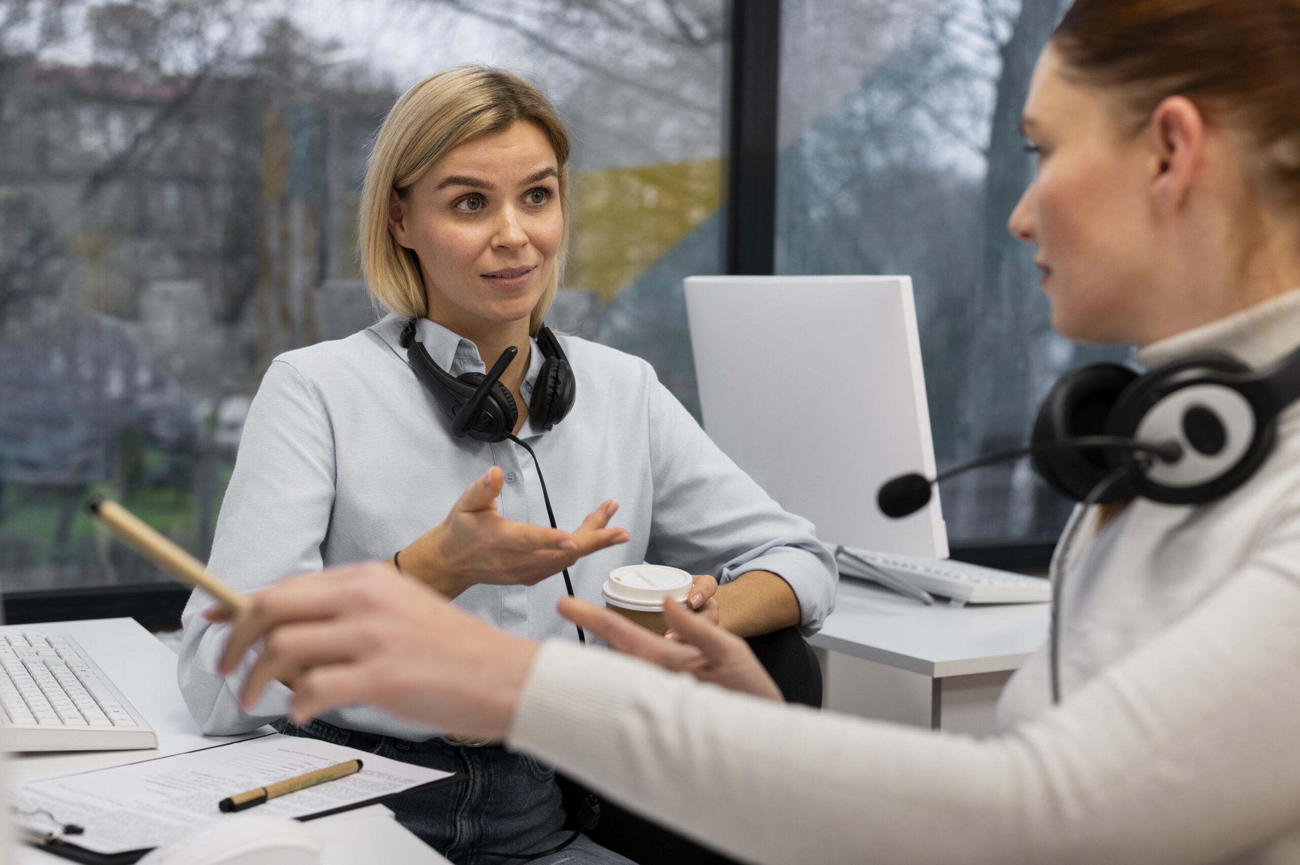 two-women-having-conversation-work-call-center-office